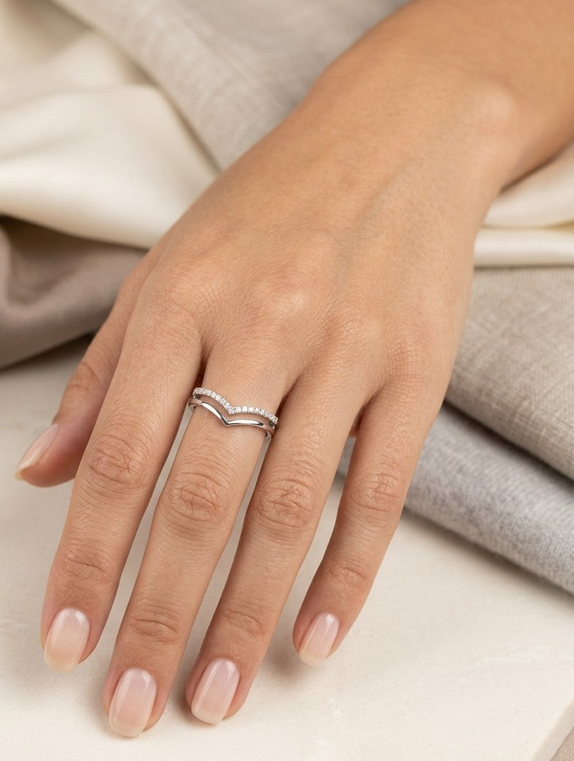 18K white gold diamond chevron wedding band with a layered polished and diamond-set V-shaped design by Emirates Diamonds.