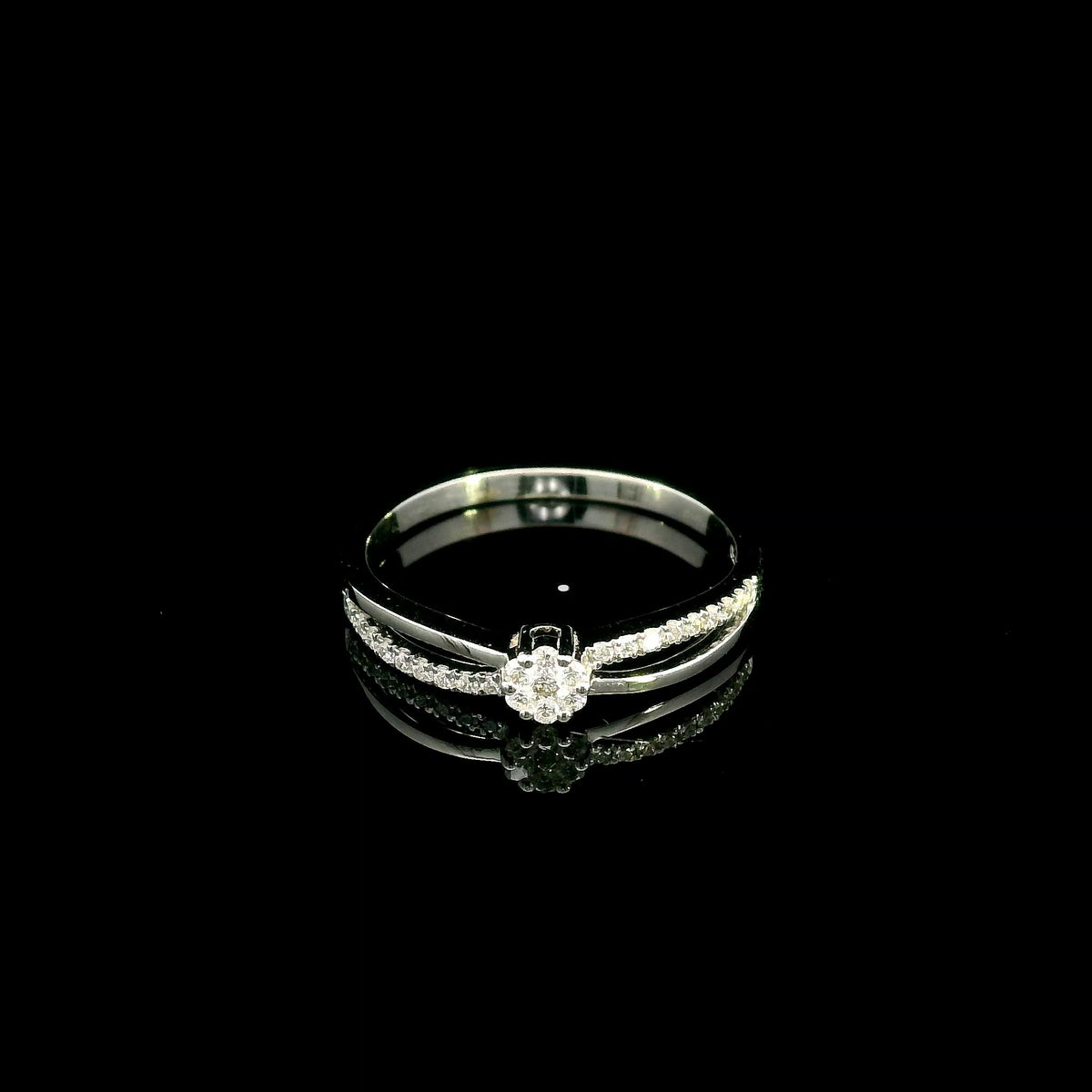 Diamond cluster ring in 18K white gold featuring a floral-inspired round diamond cluster, pavé-set shoulder and polished split-shank design.