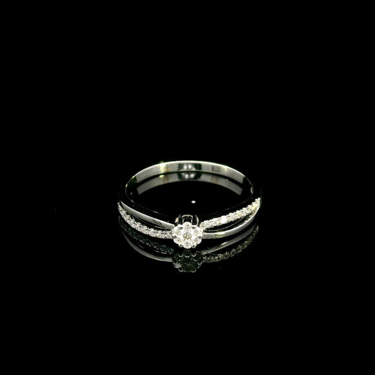 Diamond cluster ring in 18K white gold featuring a floral-inspired round diamond cluster, pavé-set shoulder and polished split-shank design.