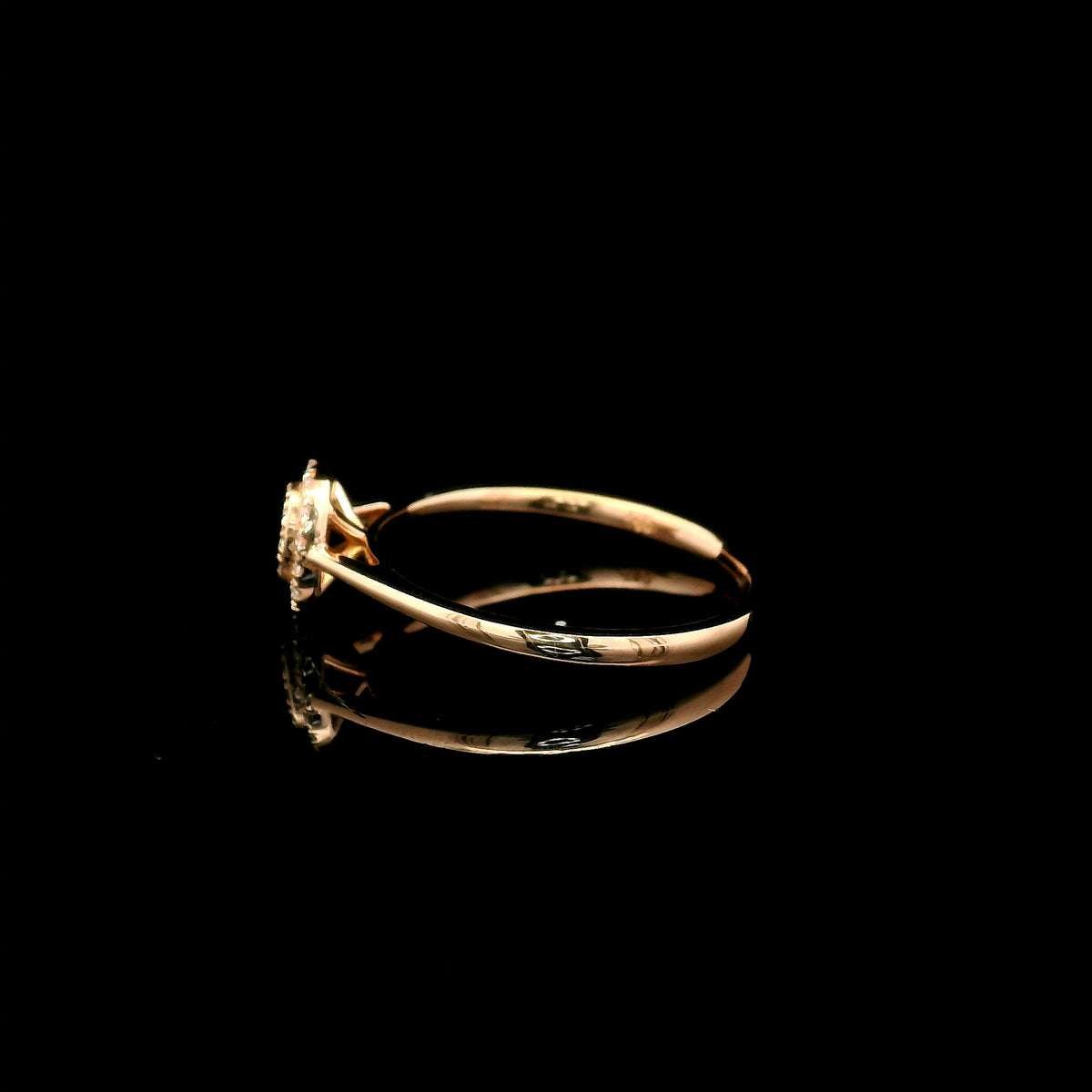 Oval diamond cluster ring in 18K rose gold with round diamonds and a slim polished band.