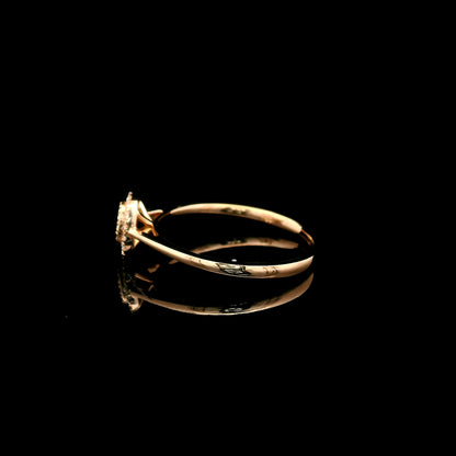Oval diamond cluster ring in 18K rose gold with round diamonds and a slim polished band.