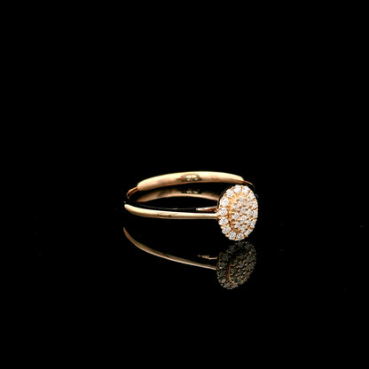 Oval diamond cluster ring in 18K rose gold with round diamonds and a slim polished band.