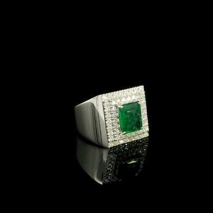 Men’s emerald and diamond statement ring in 18K white gold with rectangular green emerald and diamond surround.