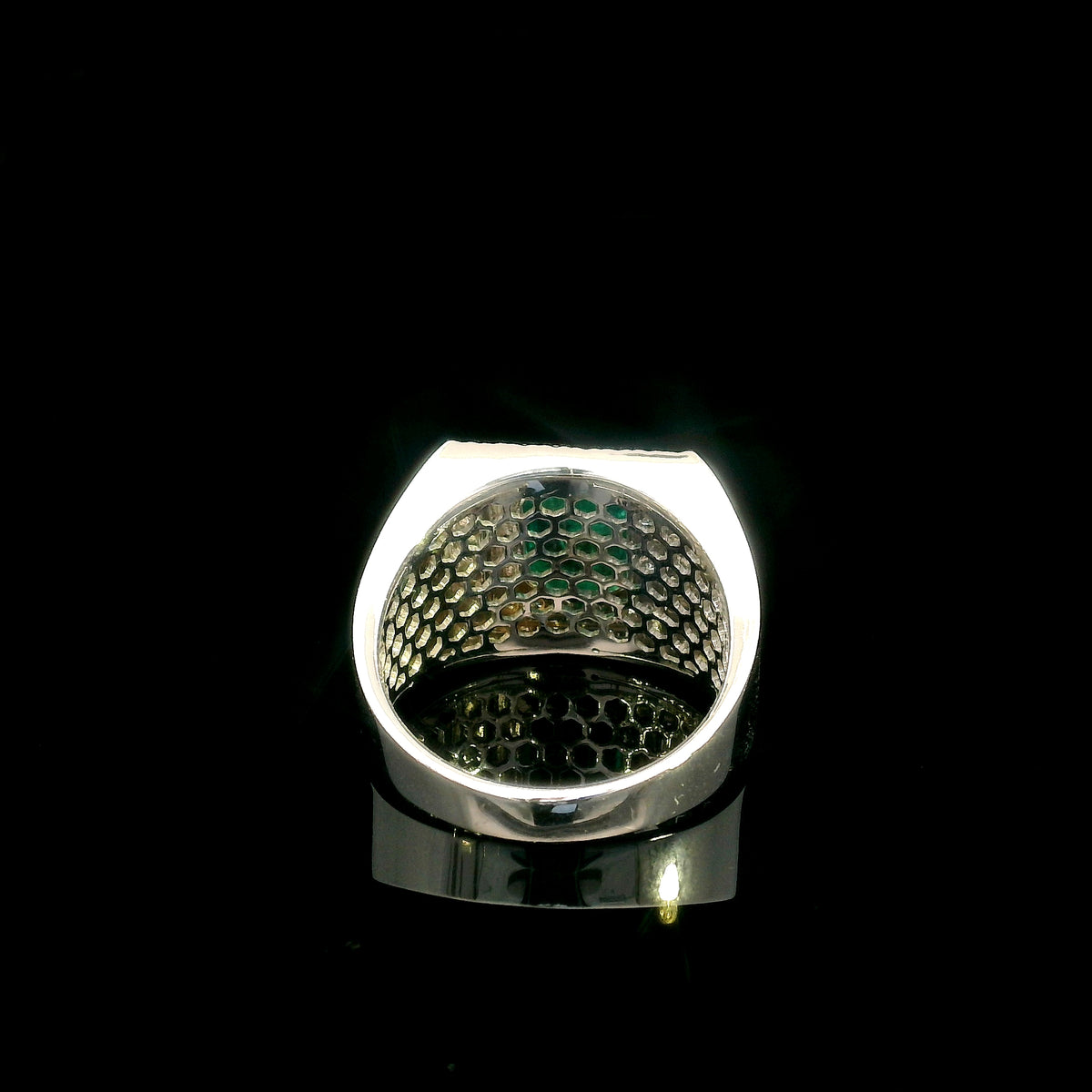 Men’s emerald and diamond statement ring in 18K white gold with rectangular green emerald and diamond surround.