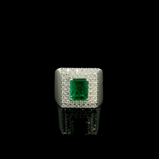Men’s emerald and diamond statement ring in 18K white gold with rectangular green emerald and diamond surround.