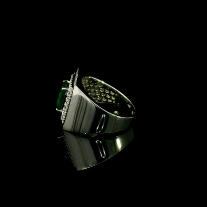 Men’s emerald and diamond statement ring in 18K white gold with rectangular green emerald and diamond surround.