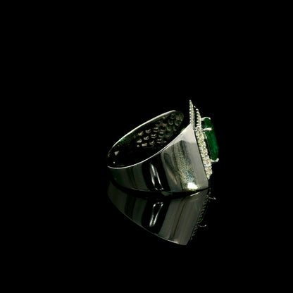 Men’s emerald and diamond statement ring in 18K white gold with rectangular green emerald and diamond surround.