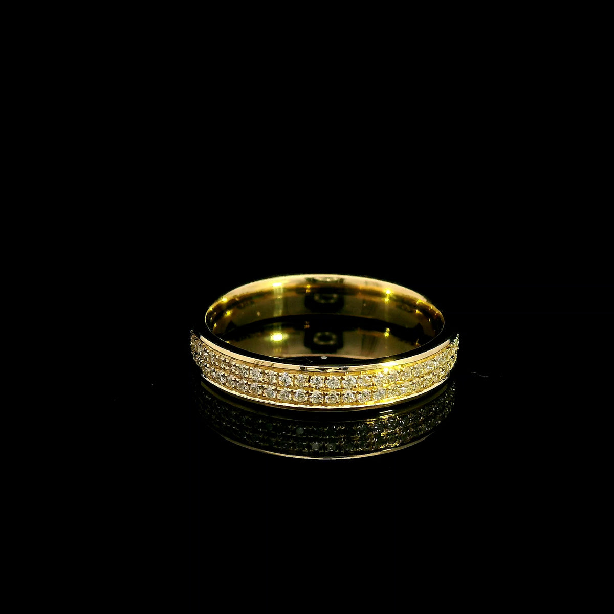 Double row diamond band ring in 18K yellow gold featuring two rows of round diamonds framed by polished gold edges.