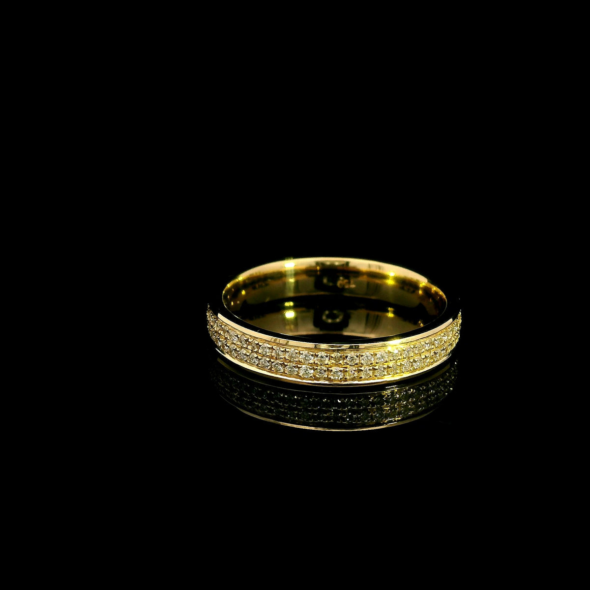 Double row diamond band ring in 18K yellow gold featuring two rows of round diamonds framed by polished gold edges.