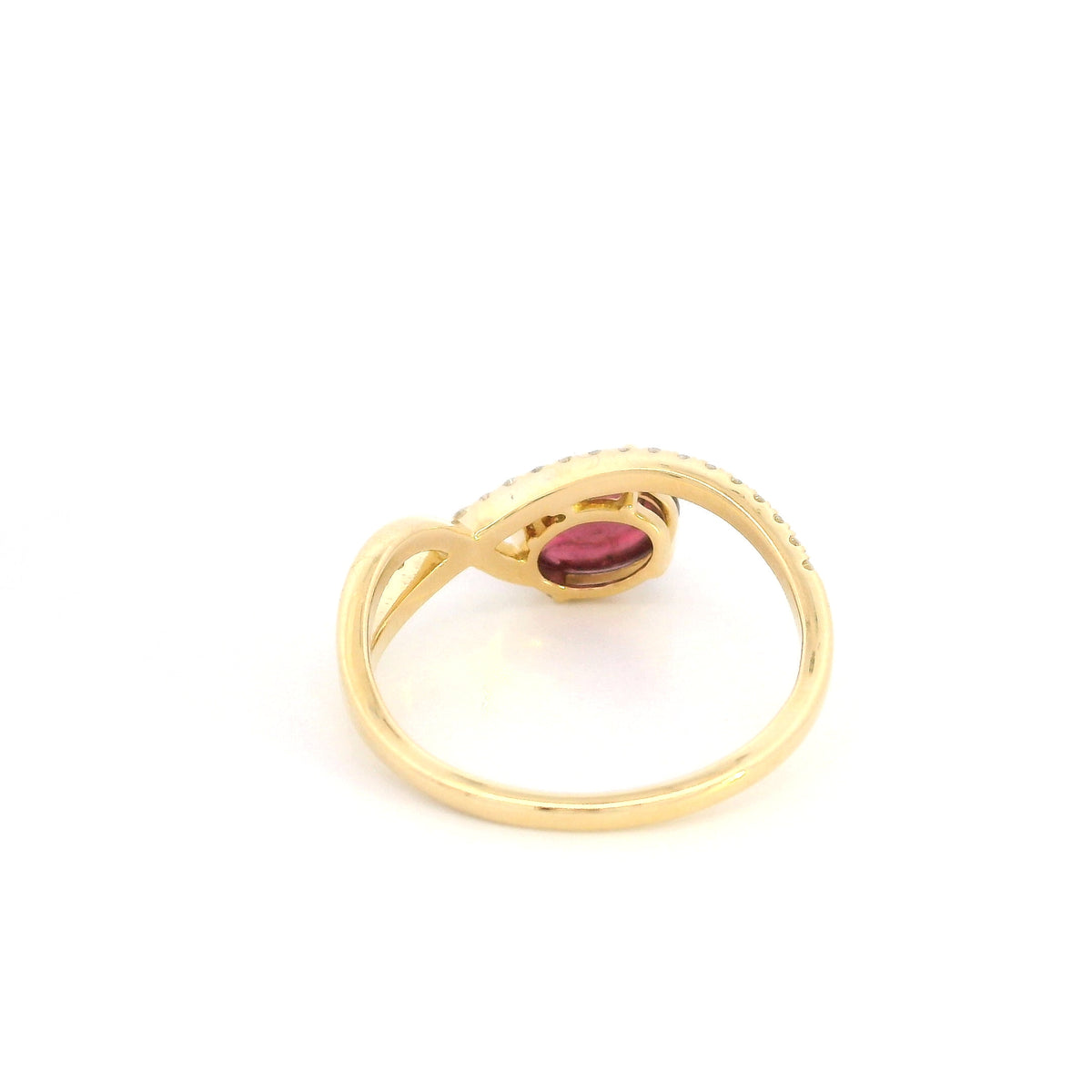 Oval cabochon ruby and diamond ring in 18K yellow gold with curved crossover band