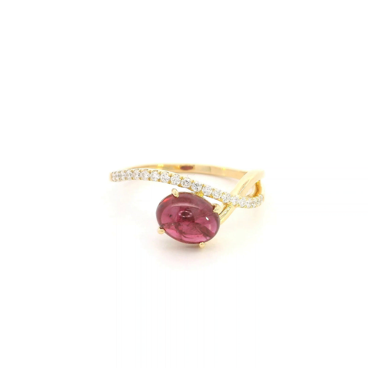 Oval cabochon ruby and diamond ring in 18K yellow gold with curved crossover band