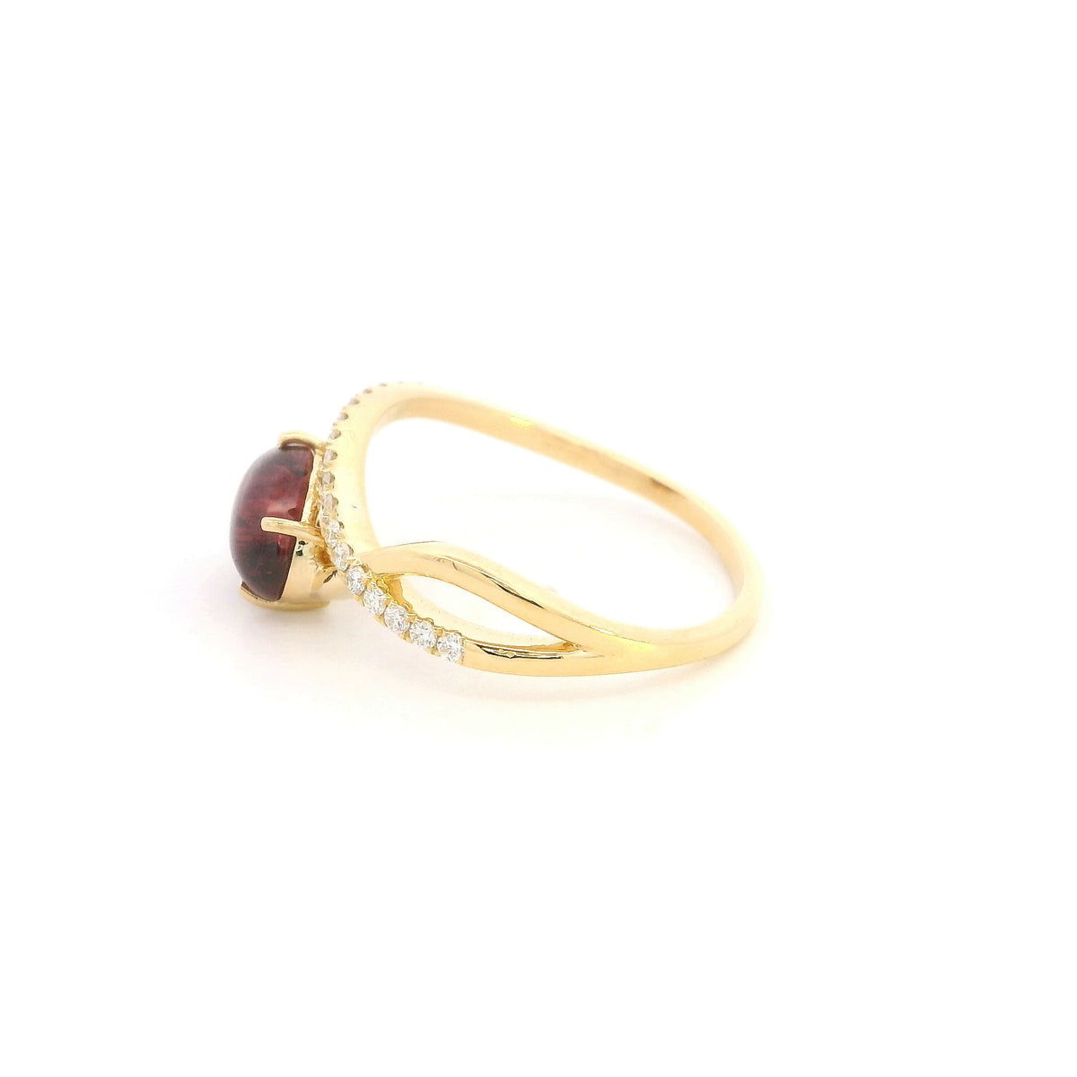 Oval cabochon ruby and diamond ring in 18K yellow gold with curved crossover band