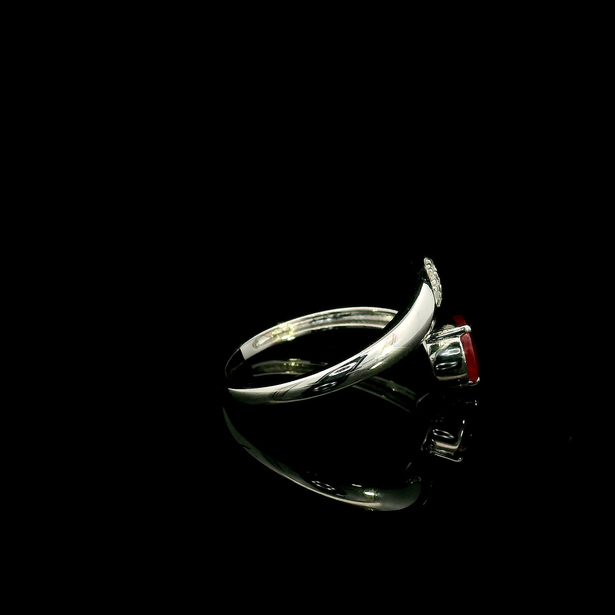 Pear shaped ruby and diamond bypass ring in 18K white gold with open teardrop design