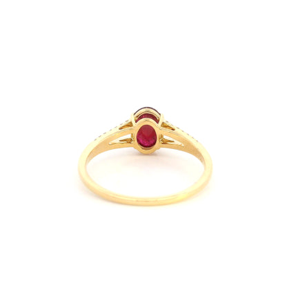 Oval cabochon ruby and diamond ring in 18K yellow gold with diamond-set split shoulders.