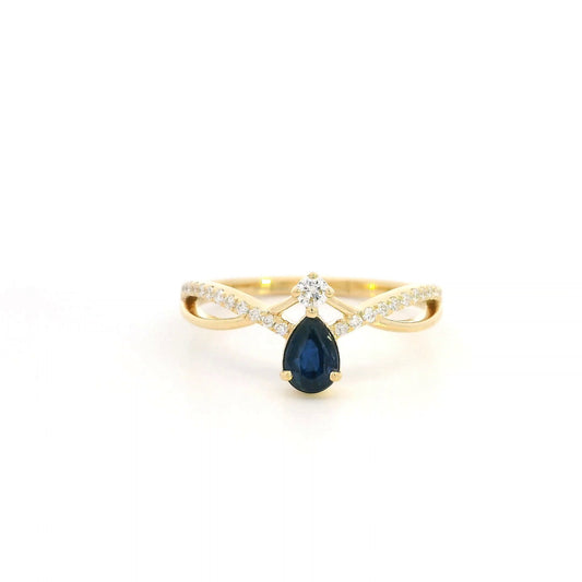 Pear shaped blue sapphire and diamond ring in 18K yellow gold with sweeping diamond-set design.
