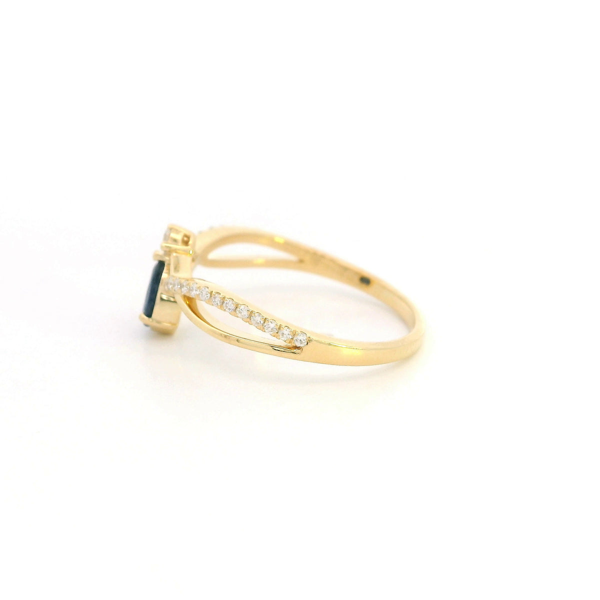 Pear shaped blue sapphire and diamond ring in 18K yellow gold with sweeping diamond-set design.