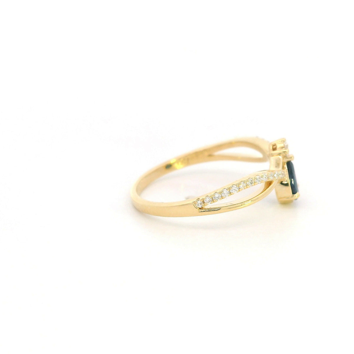 Pear shaped blue sapphire and diamond ring in 18K yellow gold with sweeping diamond-set design.