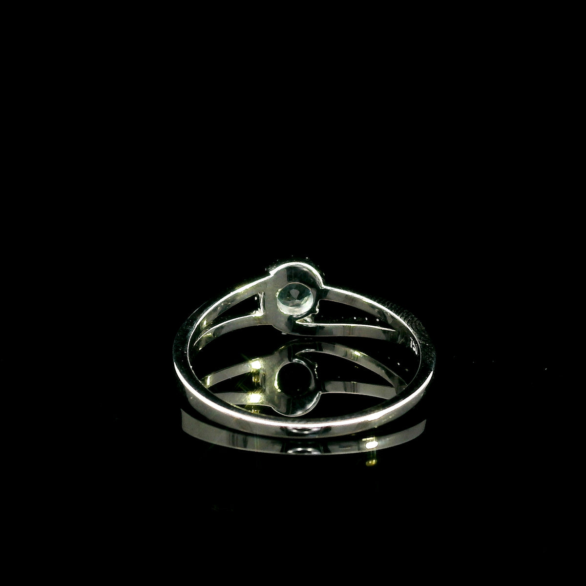 18K white gold ring with a round cut aquamarine, a curved row of diamonds wrapping around the gemstone and a polished gold band.