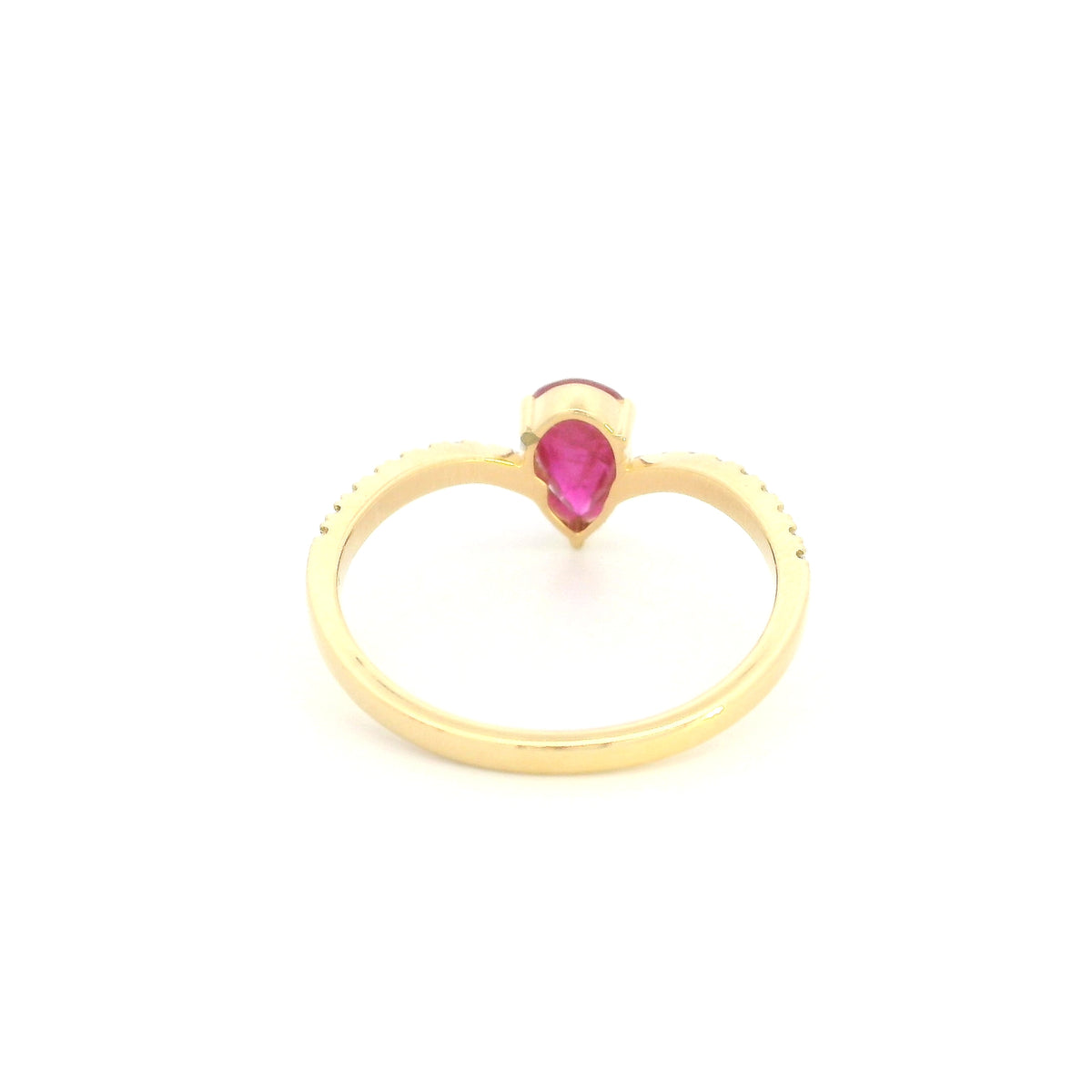 Pear shaped ruby and diamond ring in 18K yellow gold with diamond set shoulders