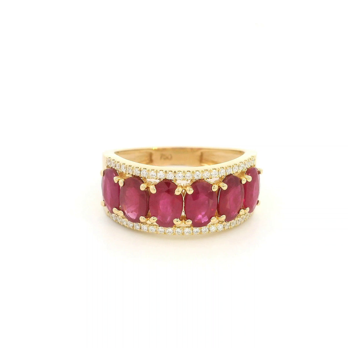 Oval ruby and diamond band ring in 18K yellow gold with a row of rubies framed by round diamonds.