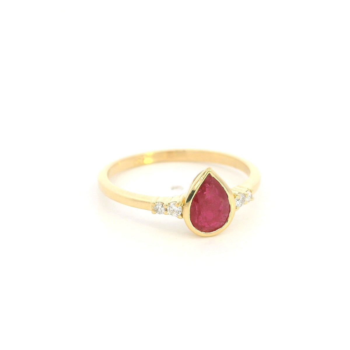 Pear-shaped red ruby ring in 18K yellow gold with a smooth bezel setting and small round diamonds along both shoulders.