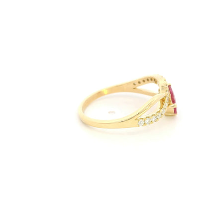 Pear shaped ruby and diamond ring in 18K yellow gold featuring a sweeping diamond-set curved band and asymmetrical design.