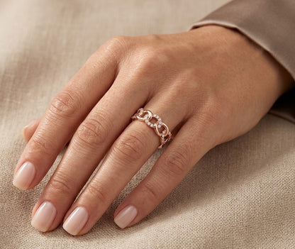 18K rose gold diamond loop ring with repeating polished and diamond-set curved motifs.