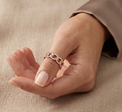 18K rose gold diamond loop ring with repeating polished and diamond-set curved motifs.