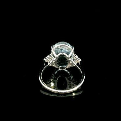 Oval aquamarine and diamond statement ring in 18K white gold with diamond side accents