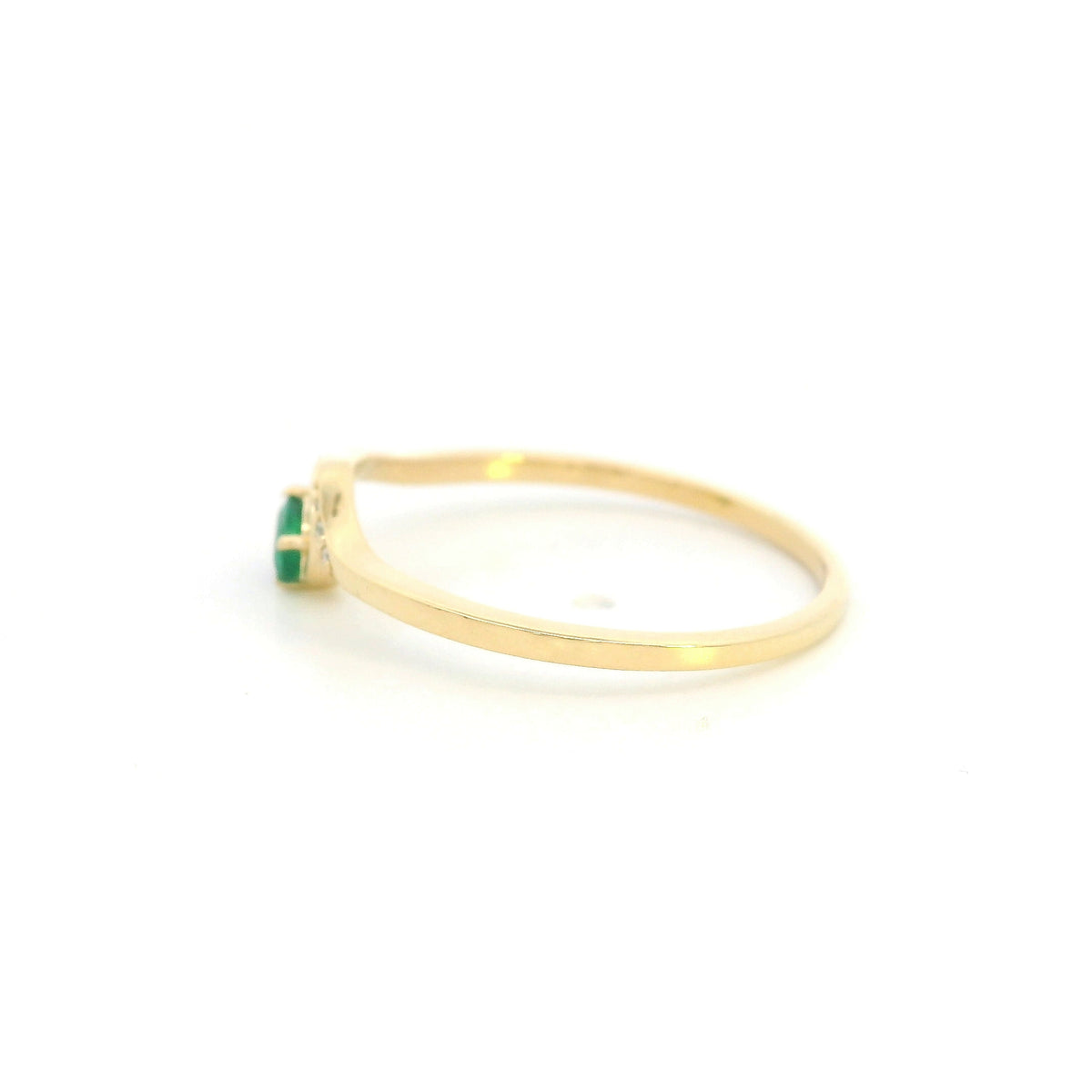 Dainty emerald and diamond ring in 18K yellow gold with curved asymmetrical design