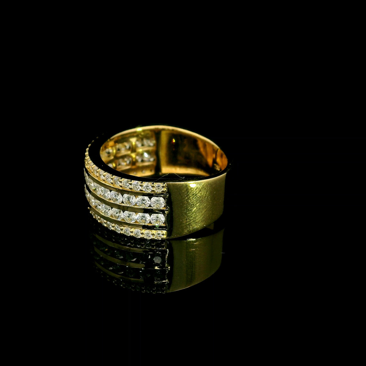 Wide diamond band ring in 18K yellow gold featuring four rows of round diamonds separated by polished gold bands.