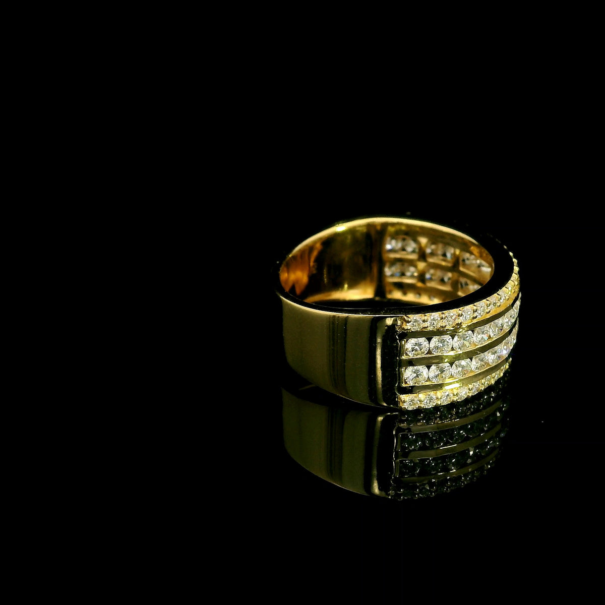 Wide diamond band ring in 18K yellow gold featuring four rows of round diamonds separated by polished gold bands.
