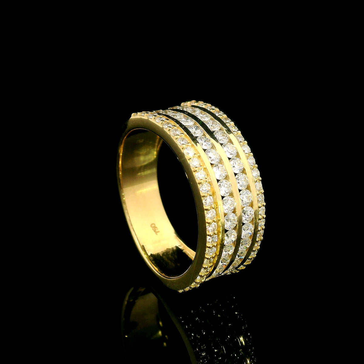 Wide diamond band ring in 18K yellow gold featuring four rows of round diamonds separated by polished gold bands.