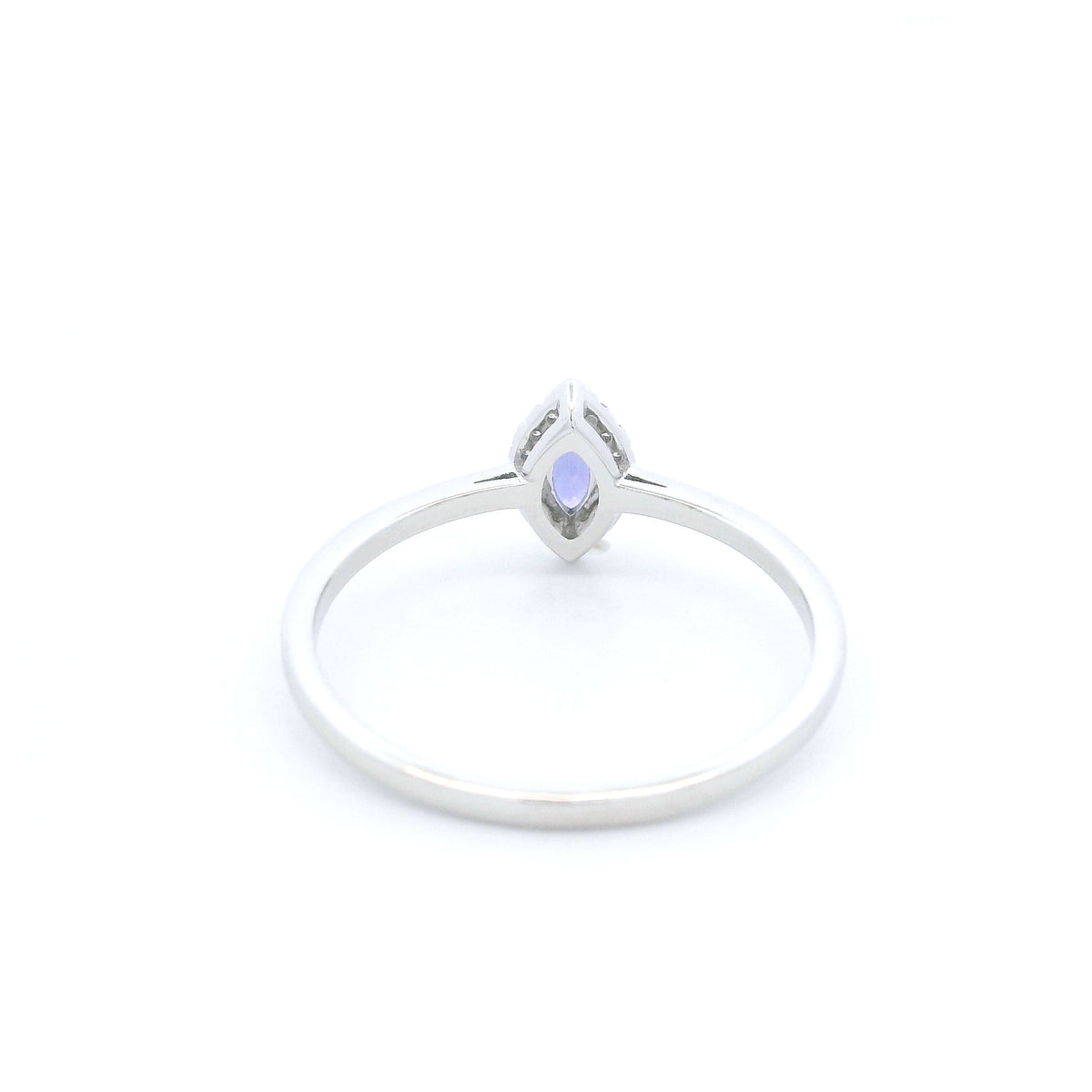 Dainty marquise tanzanite and diamond halo ring in 18K white gold with a slim polished band.