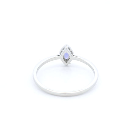 Dainty marquise tanzanite and diamond halo ring in 18K white gold with a slim polished band.