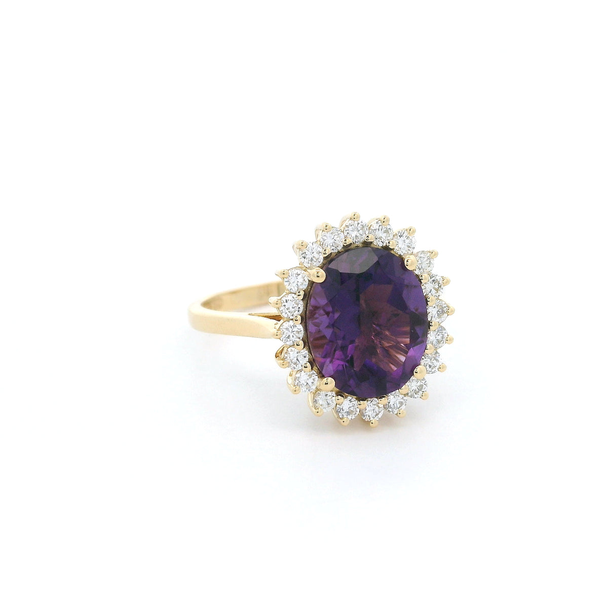 Oval amethyst and diamond halo ring in 18K yellow gold