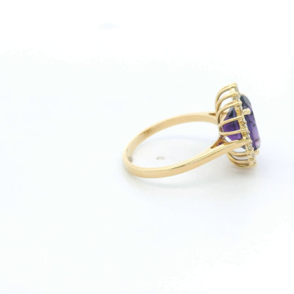 Oval amethyst and diamond halo ring in 18K yellow gold
