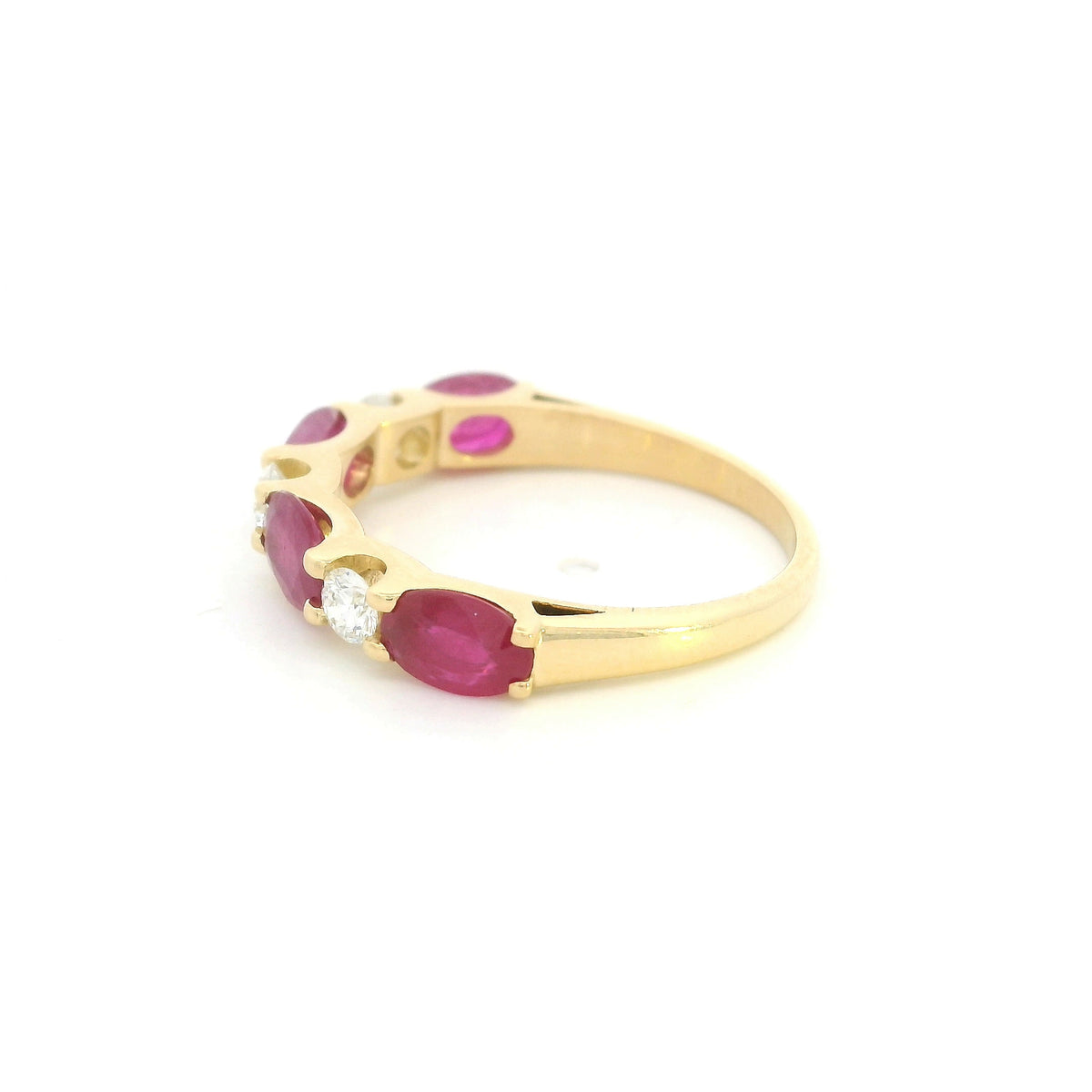 Ruby and diamond ring in 18K yellow gold with alternating oval rubies and round diamonds