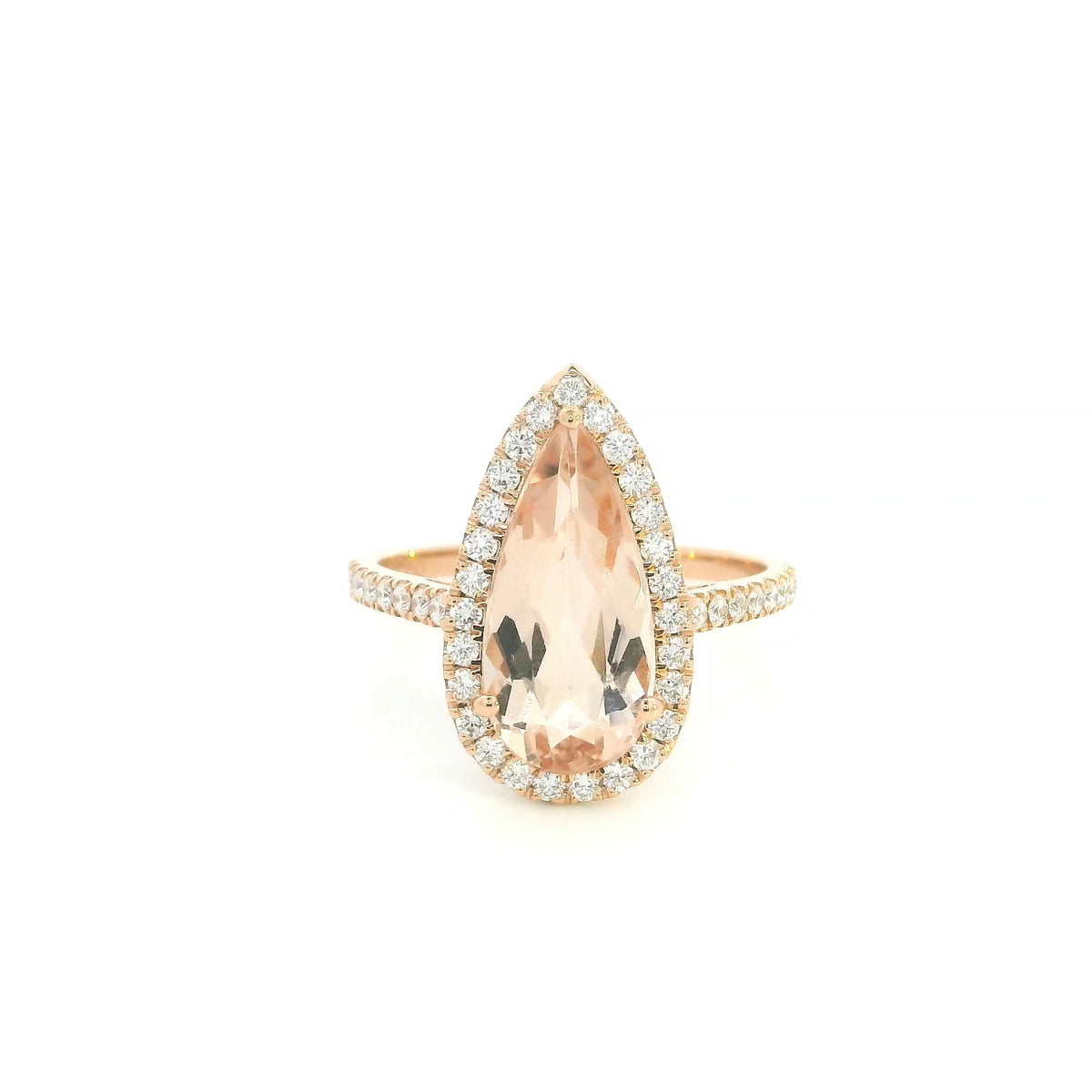Pear shaped morganite ring in 18K rose gold with a 2.58 carat pink gemstone, round diamond halo and pavé diamond band.