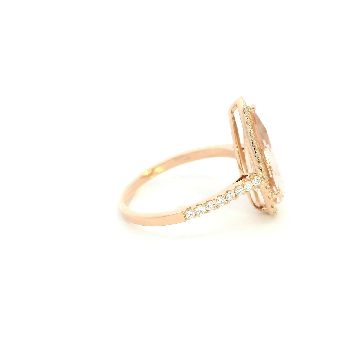 Pear shaped morganite ring in 18K rose gold with a 2.58 carat pink gemstone, round diamond halo and pavé diamond band.