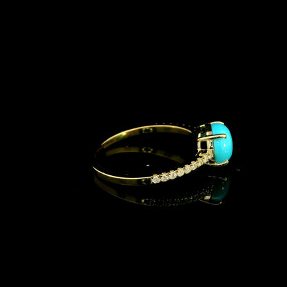 18K yellow gold turquoise and diamond ring featuring a round cabochon turquoise gemstone in a four-prong setting with round diamonds along the band.