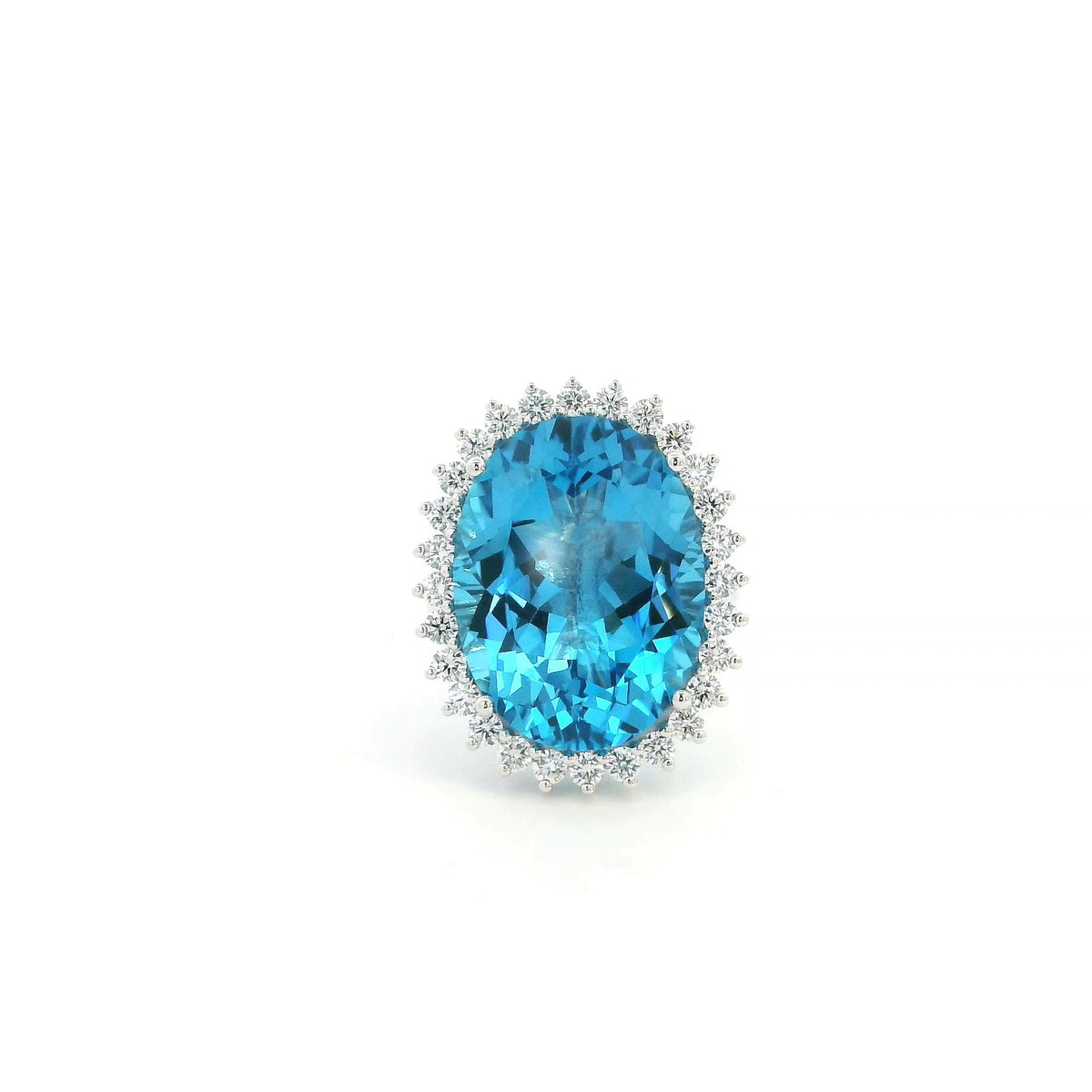 Swiss Blue Topaz halo ring in 18K white gold with an oval blue gemstone surrounded by round diamonds.