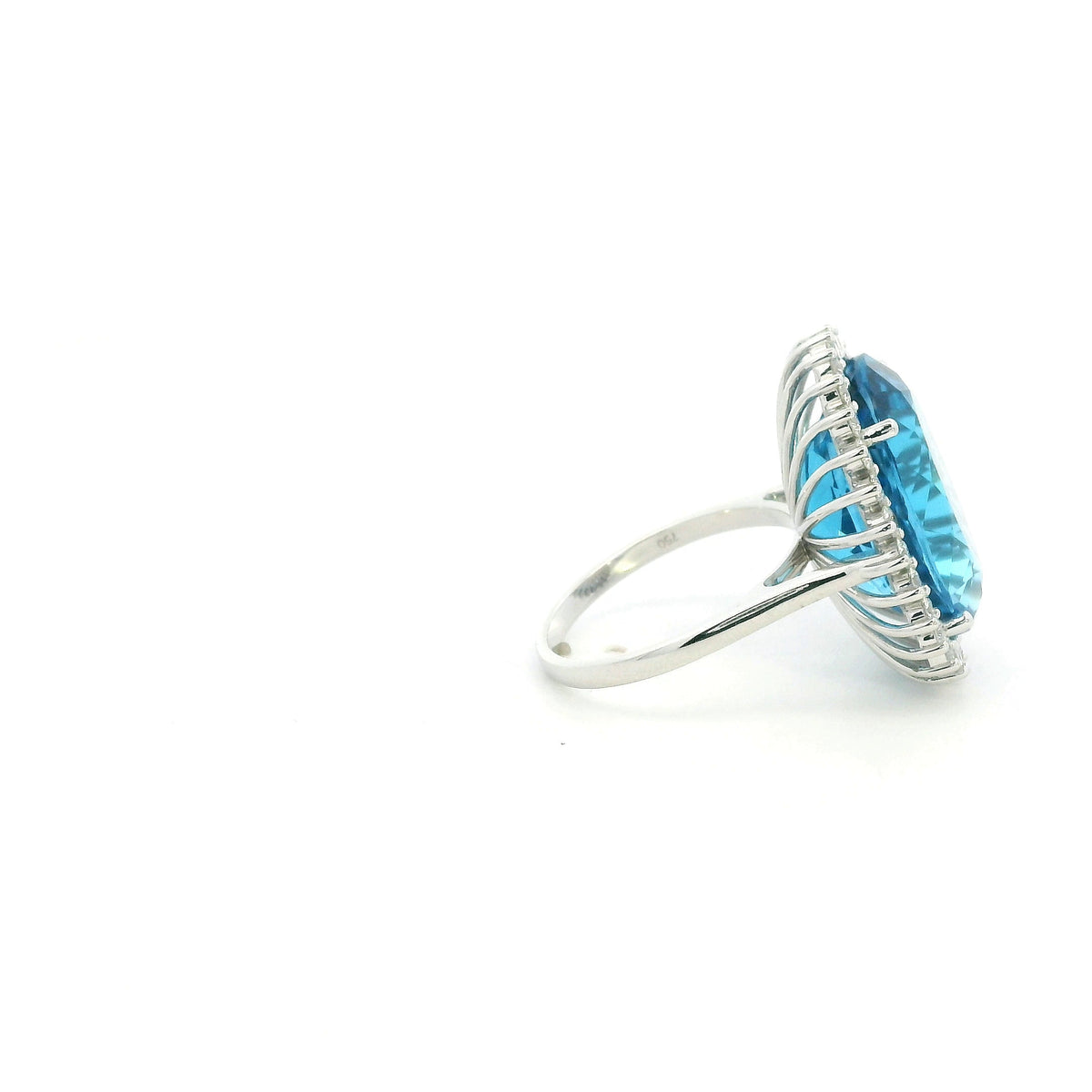 Swiss Blue Topaz halo ring in 18K white gold with an oval blue gemstone surrounded by round diamonds.