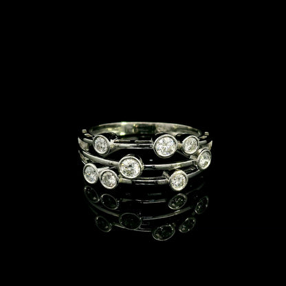 Diamond bezel set multi-row ring in 18K white gold featuring asymmetrically arranged round diamonds across polished open bands.