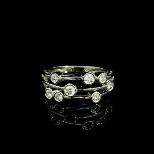 Diamond bezel set multi-row ring in 18K white gold featuring asymmetrically arranged round diamonds across polished open bands.