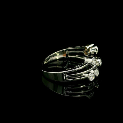 Diamond bezel set multi-row ring in 18K white gold featuring asymmetrically arranged round diamonds across polished open bands.