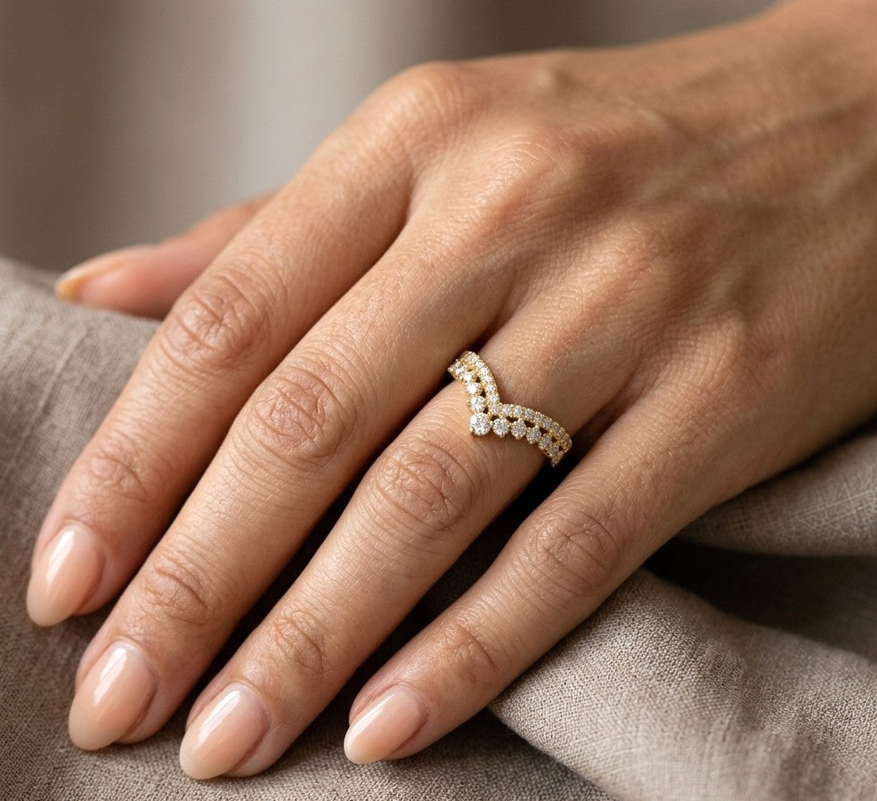 V shaped diamond chevron ring in 18K yellow gold featuring pavé-set diamonds and graduated round diamonds, designed as a statement ring or contour wedding band.