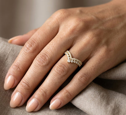 V shaped diamond chevron ring in 18K yellow gold featuring pavé-set diamonds and graduated round diamonds, designed as a statement ring or contour wedding band.