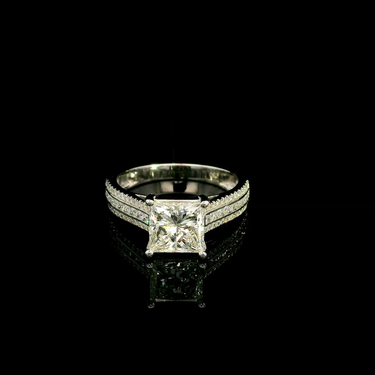 Natural princess cut diamond engagement ring in 18K white gold featuring a 2.19 carat IGI-certified F colour VS1 clarity centre diamond and 0.42 carat of round diamonds along the pavé-set band.