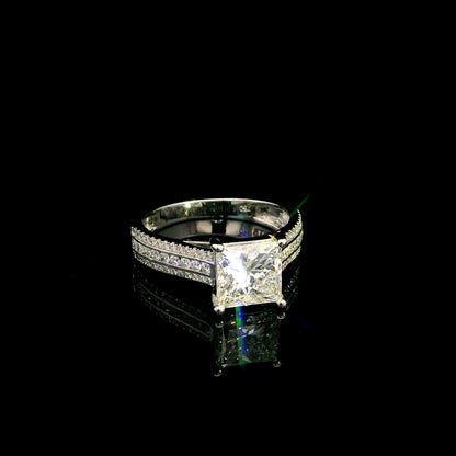 Natural princess cut diamond engagement ring in 18K white gold featuring a 2.19 carat IGI-certified F colour VS1 clarity centre diamond and 0.42 carat of round diamonds along the pavé-set band.